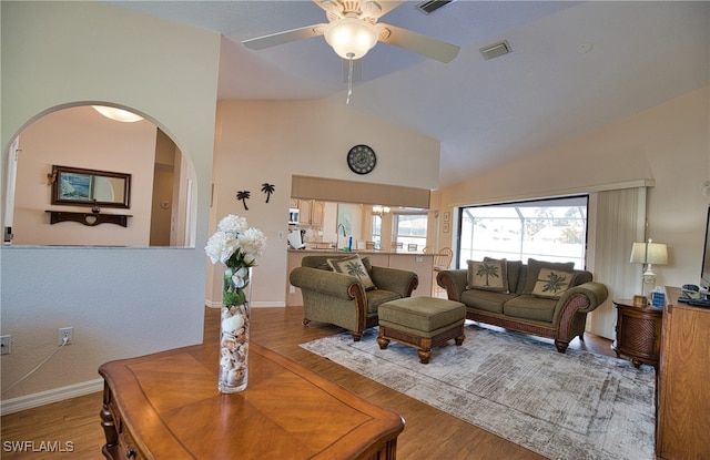 living room featuring lofted ceiling, hardwood / wood-style floors, sink, and ceiling fan