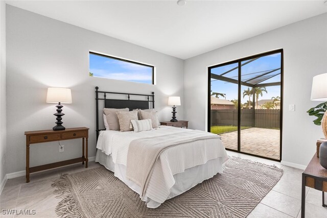 bedroom featuring multiple windows, light tile patterned floors, and access to exterior