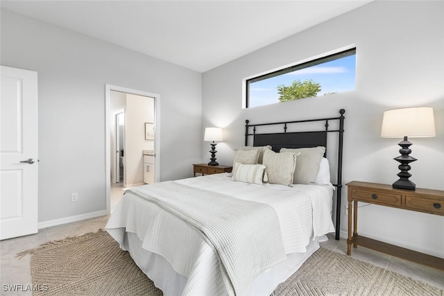 tiled bedroom featuring ensuite bath