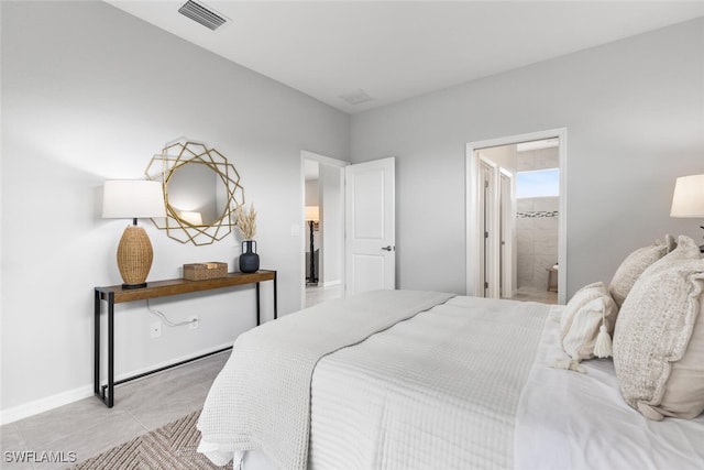 bedroom featuring tile patterned flooring, visible vents, ensuite bath, and baseboards