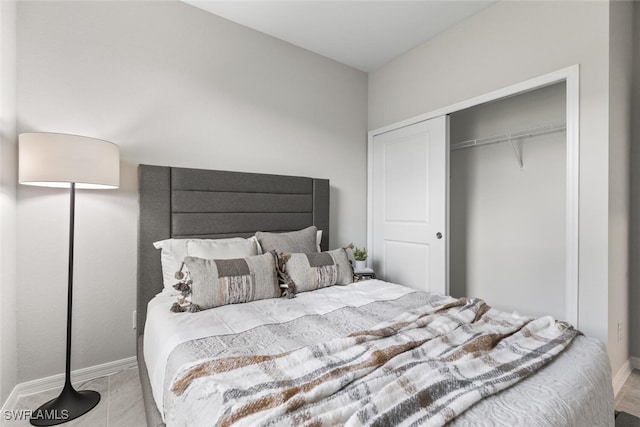 bedroom featuring a closet and baseboards