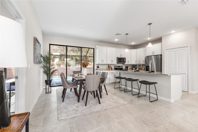 dining room with recessed lighting, visible vents, and baseboards