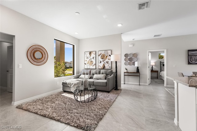 living area featuring visible vents and baseboards