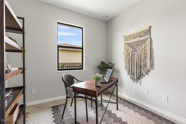 tiled home office featuring baseboards