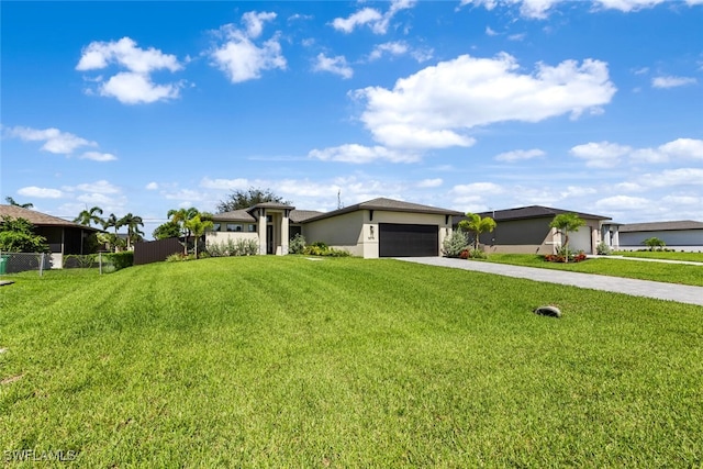 view of front of house featuring a garage, fence, concrete driveway, stucco siding, and a front yard