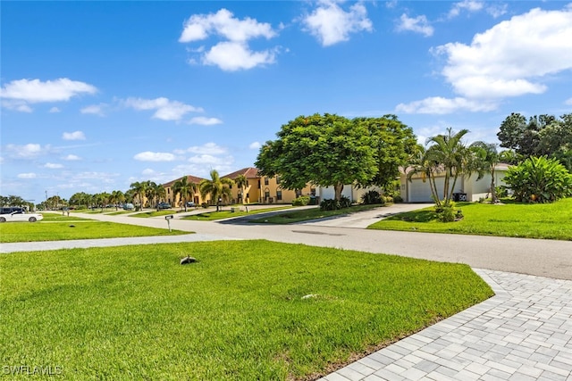 surrounding community with a garage and a lawn