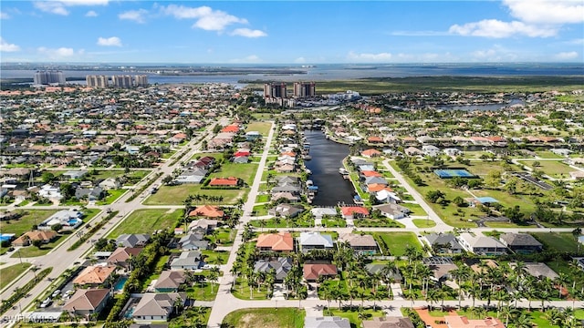 drone / aerial view featuring a water view and a residential view