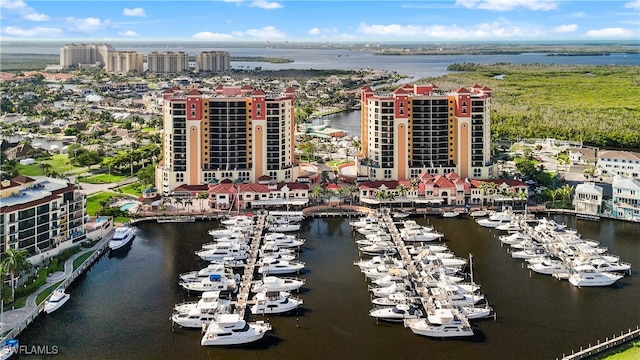 birds eye view of property with a water view and a view of city