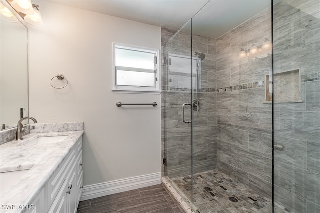 bathroom featuring walk in shower and vanity