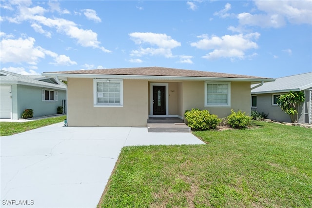 single story home with a front yard and a garage