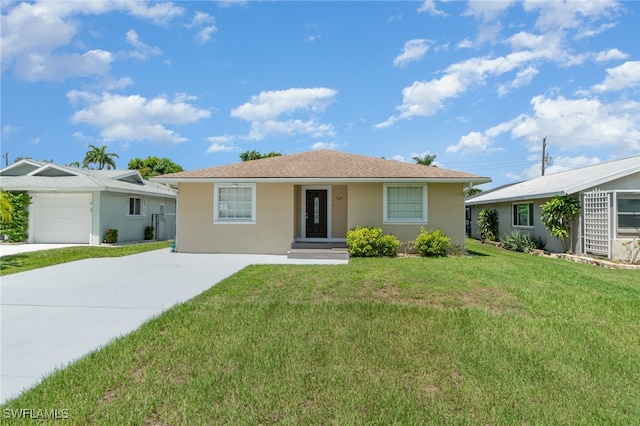 single story home with a garage and a front lawn