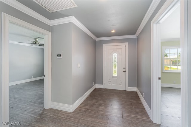 entryway with ceiling fan and crown molding