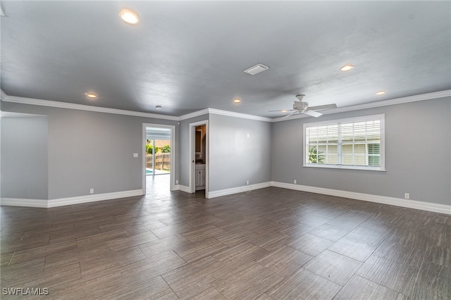 spare room with crown molding, a healthy amount of sunlight, ceiling fan, and dark hardwood / wood-style floors