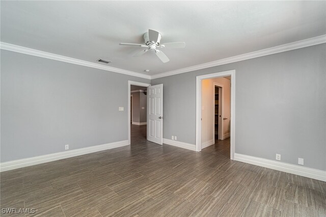 empty room featuring ornamental molding, ceiling fan, and dark hardwood / wood-style floors