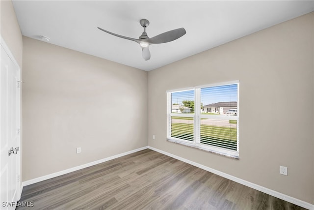 spare room with ceiling fan and hardwood / wood-style flooring