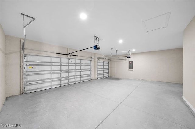 garage with a garage door opener and electric panel