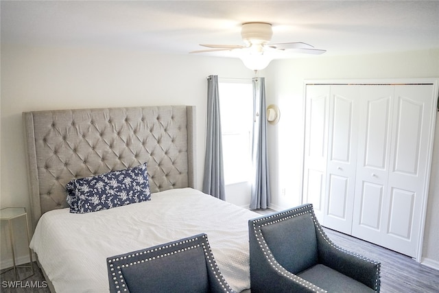 bedroom with ceiling fan, a closet, and wood-type flooring