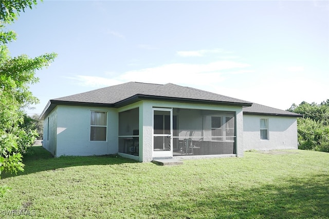 back of house with a lawn and a sunroom