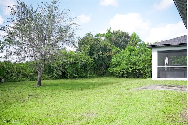 view of yard featuring a sunroom