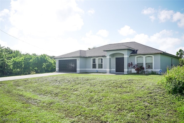 view of front of house with a garage and a front yard