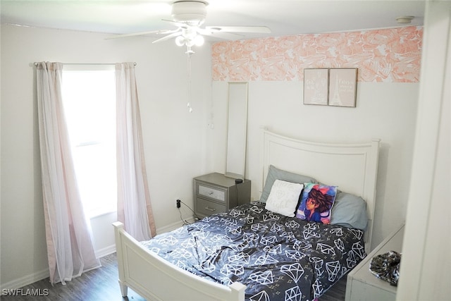 bedroom with multiple windows, ceiling fan, and wood-type flooring