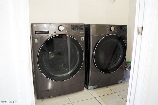 laundry area featuring independent washer and dryer and light tile patterned floors