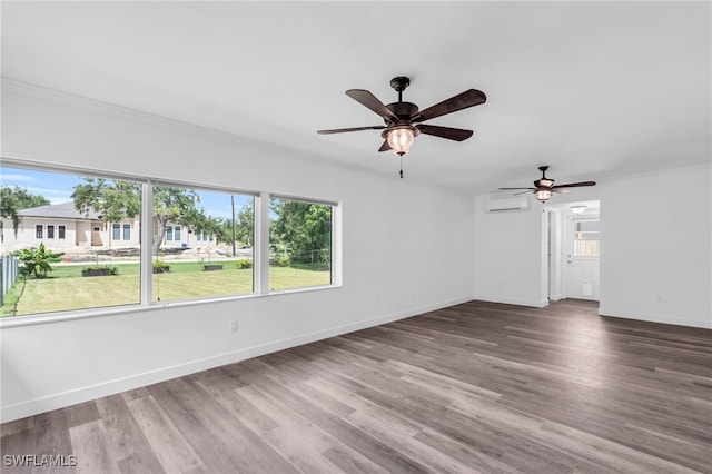 empty room with wood-type flooring, a wall mounted air conditioner, ornamental molding, and ceiling fan