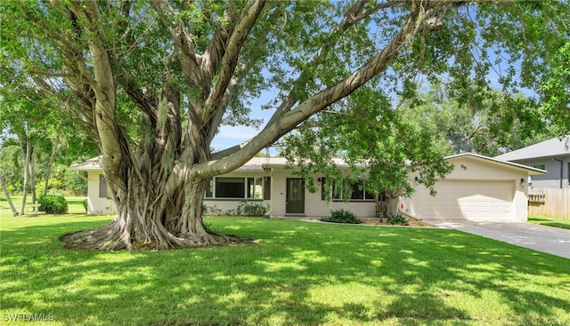 single story home with a front yard and a garage