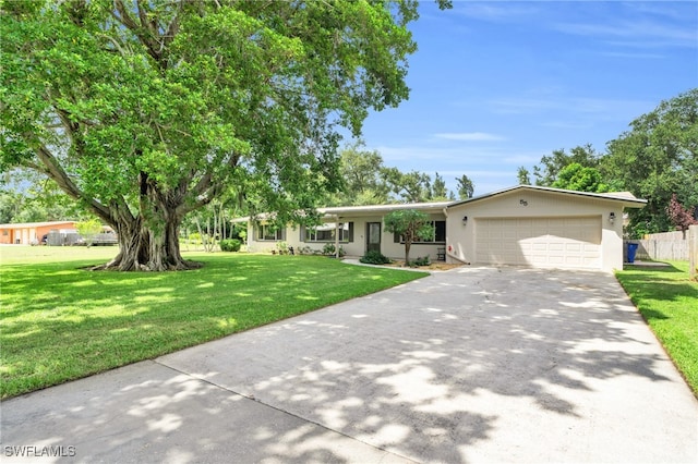 view of front of house with a front yard and a garage