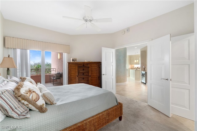 carpeted bedroom with beverage cooler, ceiling fan, and access to outside