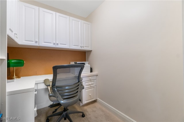 office space featuring light carpet and built in desk