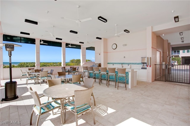 dining space with light wood-type flooring, ceiling fan, and plenty of natural light