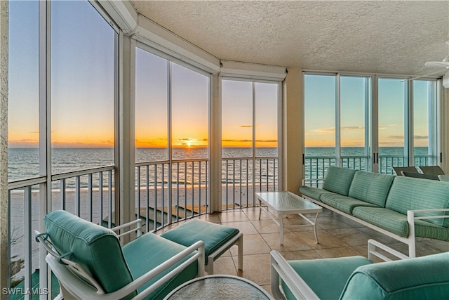 sunroom / solarium with a water view and plenty of natural light