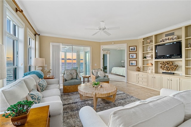 tiled living room with built in features, ceiling fan, and crown molding