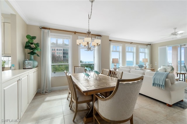 tiled dining space featuring ceiling fan with notable chandelier, a water view, and crown molding