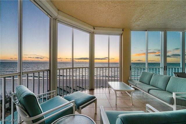 sunroom / solarium with a water view