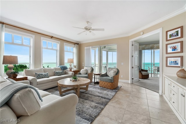 living room with ceiling fan, light tile patterned floors, ornamental molding, and a water view