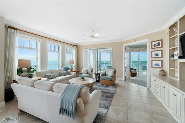 tiled living room featuring crown molding, a water view, ceiling fan, and built in features