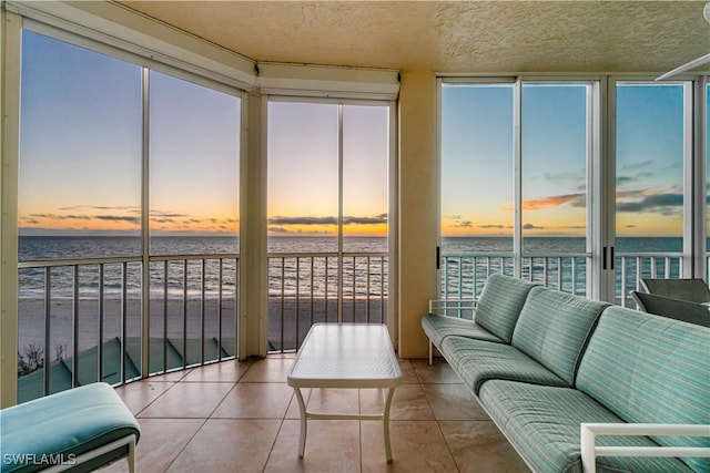 sunroom / solarium with a water view and plenty of natural light