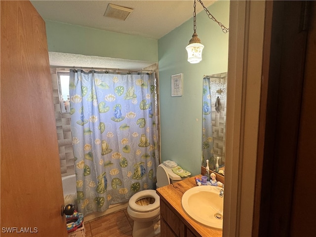 full bathroom featuring vanity, a textured ceiling, toilet, and shower / bathtub combination with curtain