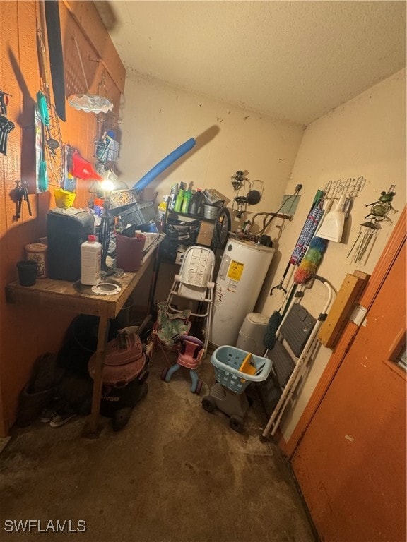 miscellaneous room with concrete floors and water heater