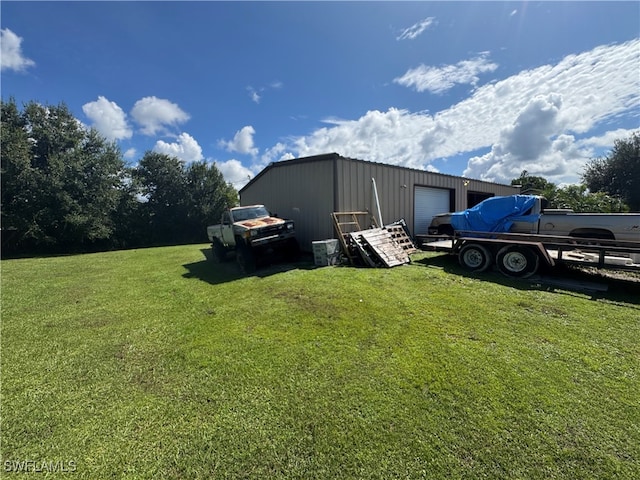 view of yard with an outbuilding and a garage