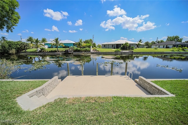 dock area featuring a water view and a yard