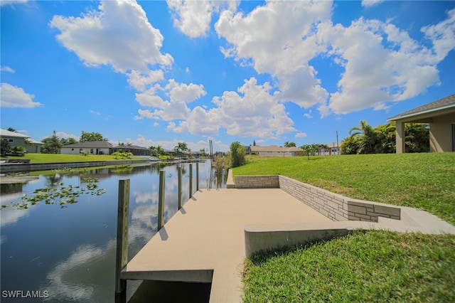 dock area featuring a water view and a yard