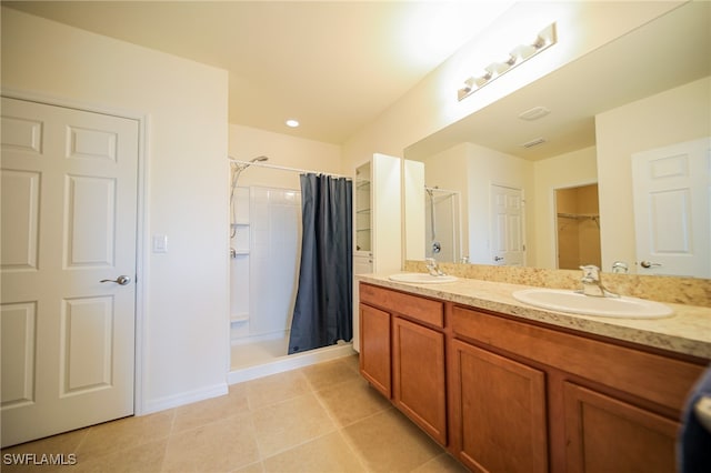 bathroom with a shower with curtain, vanity, and tile patterned flooring