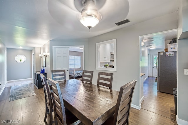 dining area with ceiling fan and hardwood / wood-style flooring