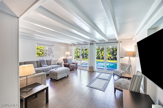 living room with a wealth of natural light, beamed ceiling, and hardwood / wood-style flooring