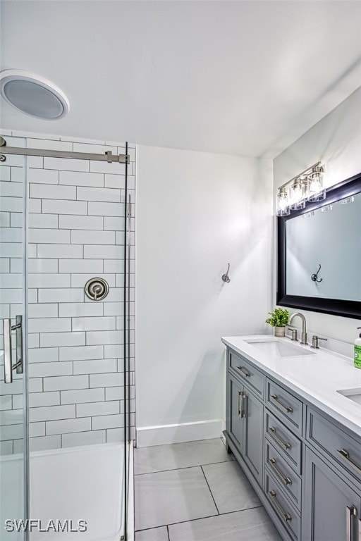 bathroom with tile patterned floors, walk in shower, and vanity