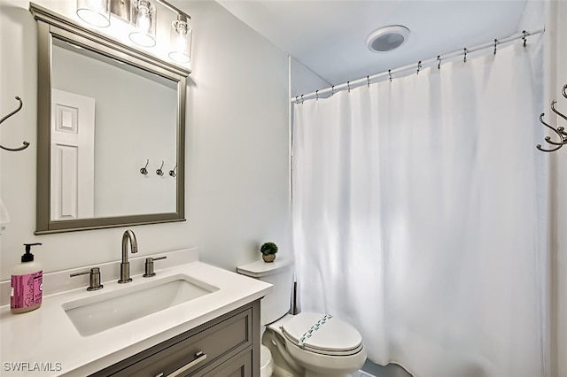 bathroom with vanity, toilet, and a shower with shower curtain