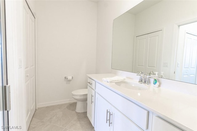 bathroom featuring toilet, vanity, and tile patterned floors